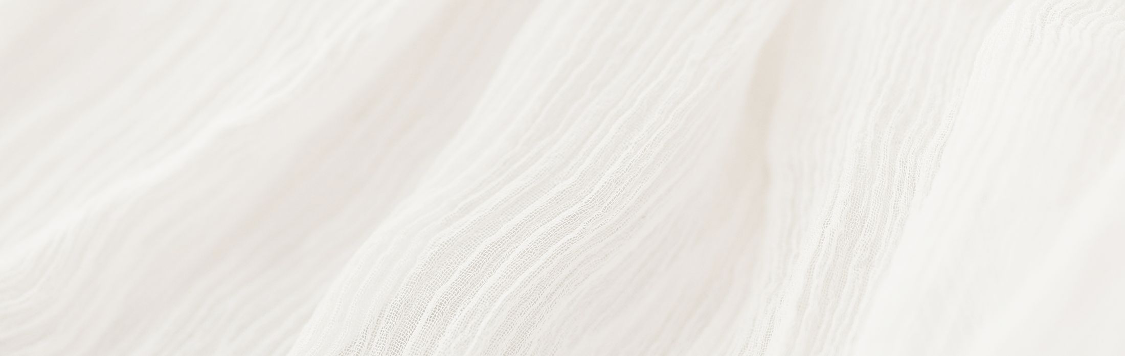 Textured white fabric with gentle ripples.