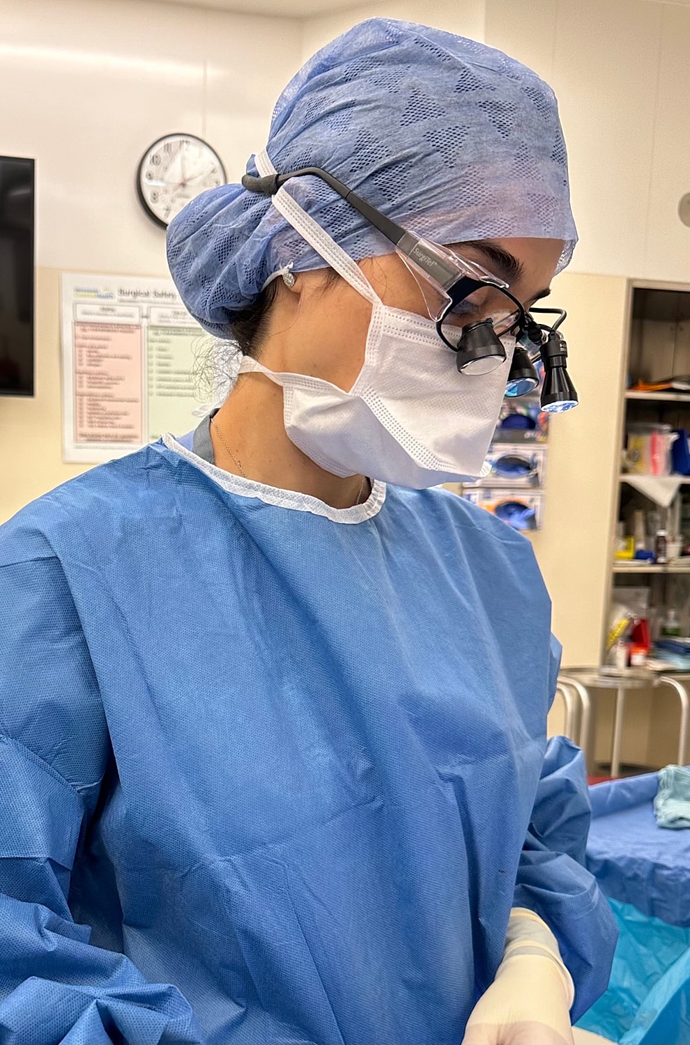 Smiling woman in cozy sweater, sitting comfortably.
