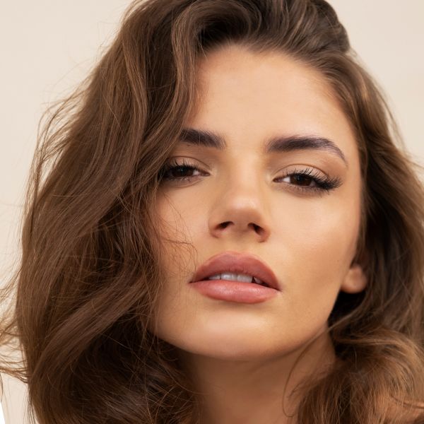 Portrait of a woman with long, wavy hair.