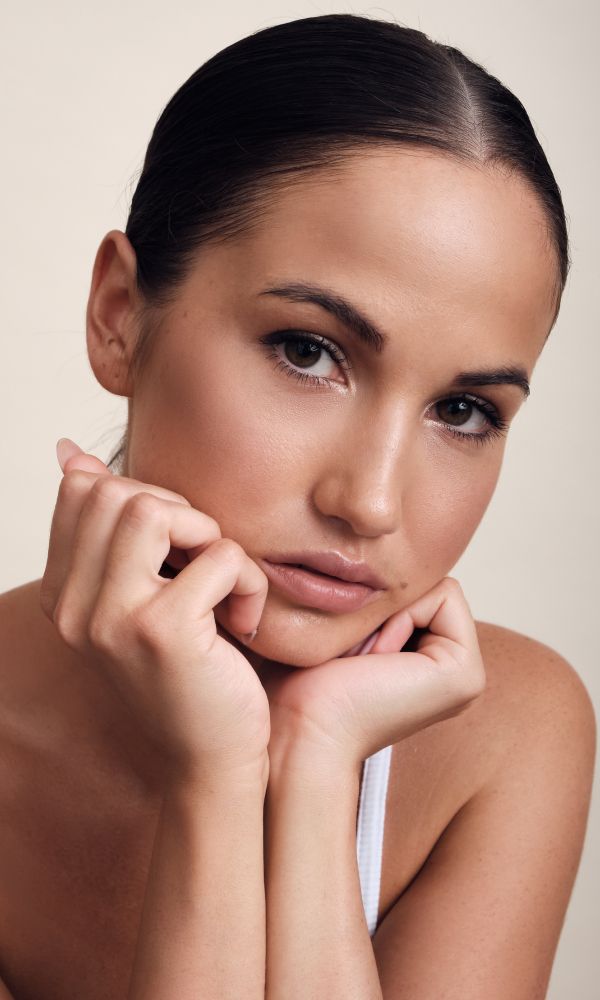Close-up of a thoughtful woman resting her chin.