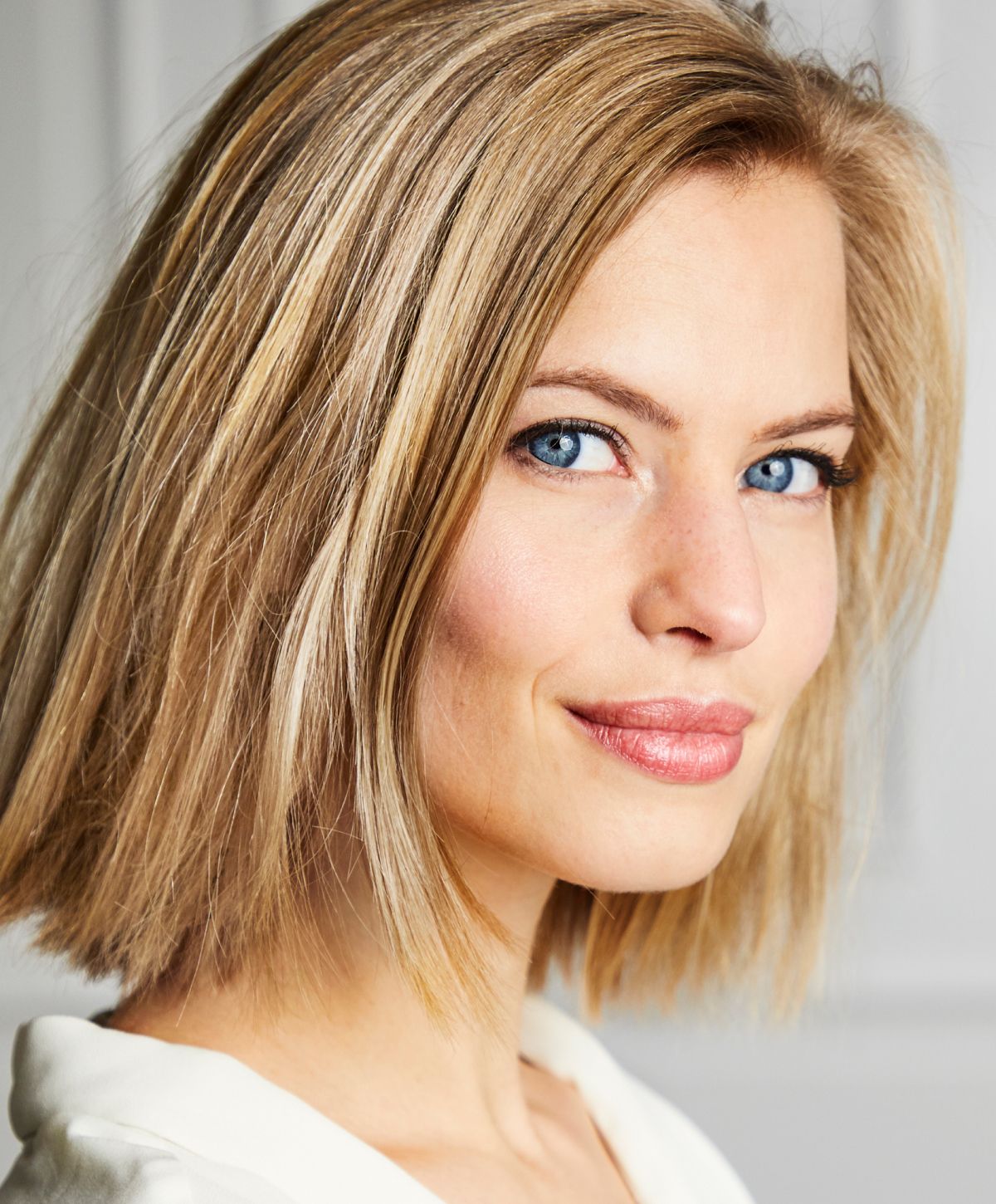 Portrait of a woman with blonde hair and blue eyes.
