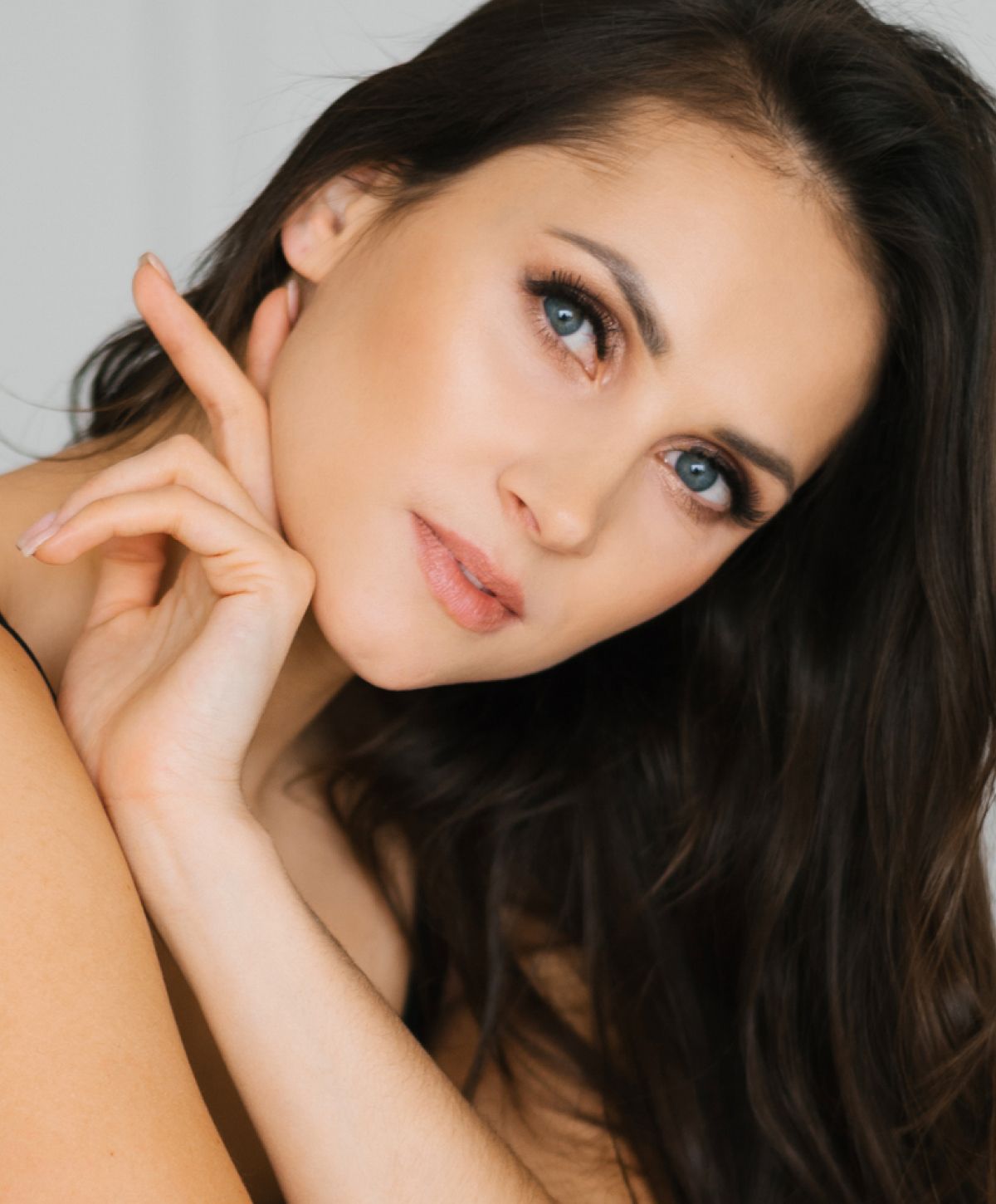 Close-up of woman with long dark hair.