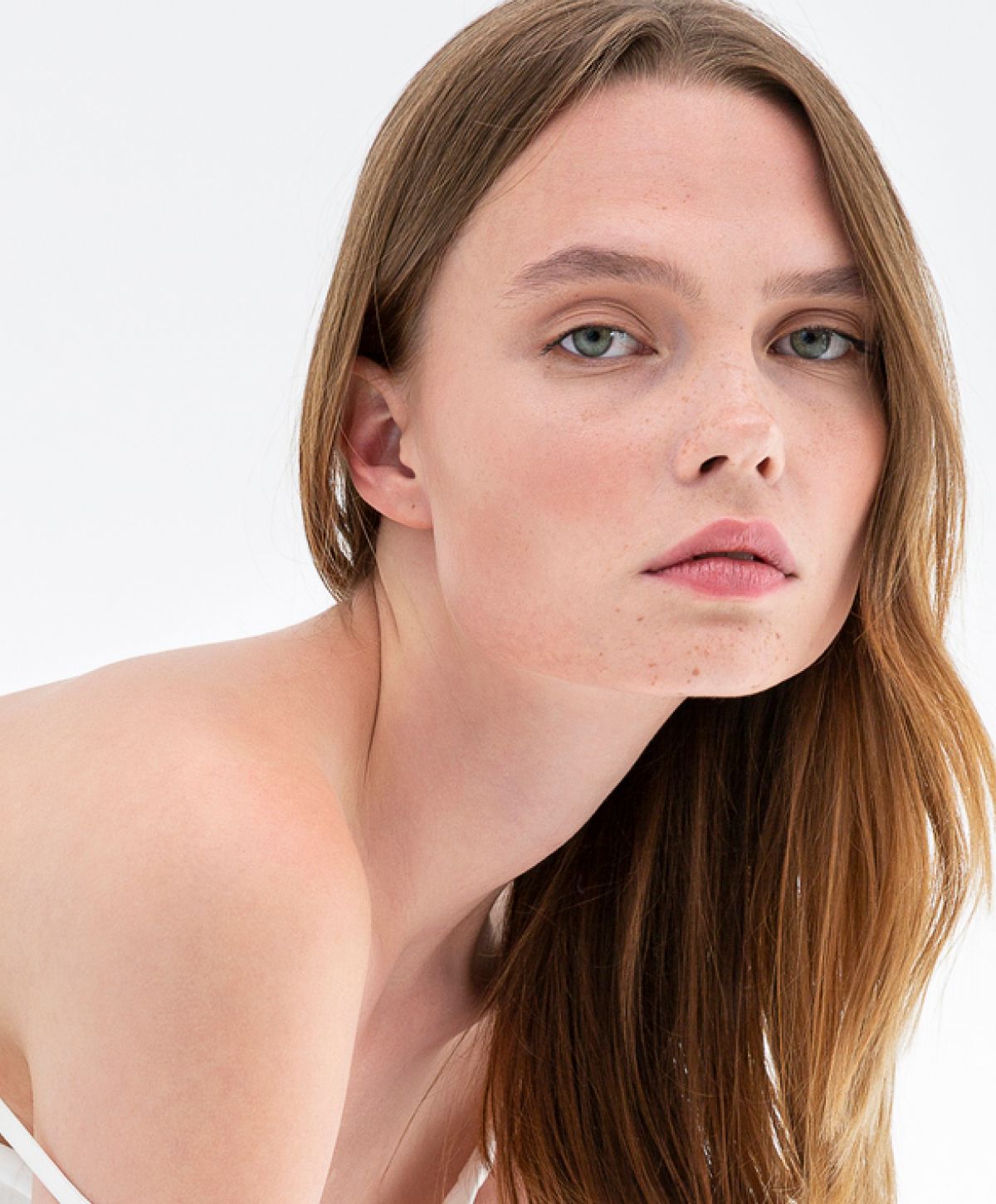 Model with long hair and natural makeup.