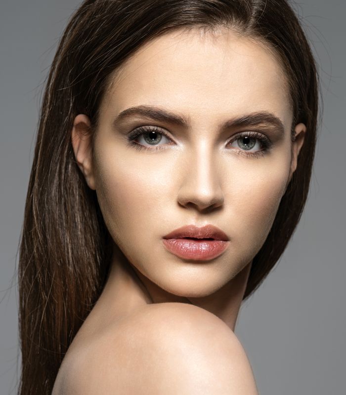 Close-up portrait of a woman with striking features.