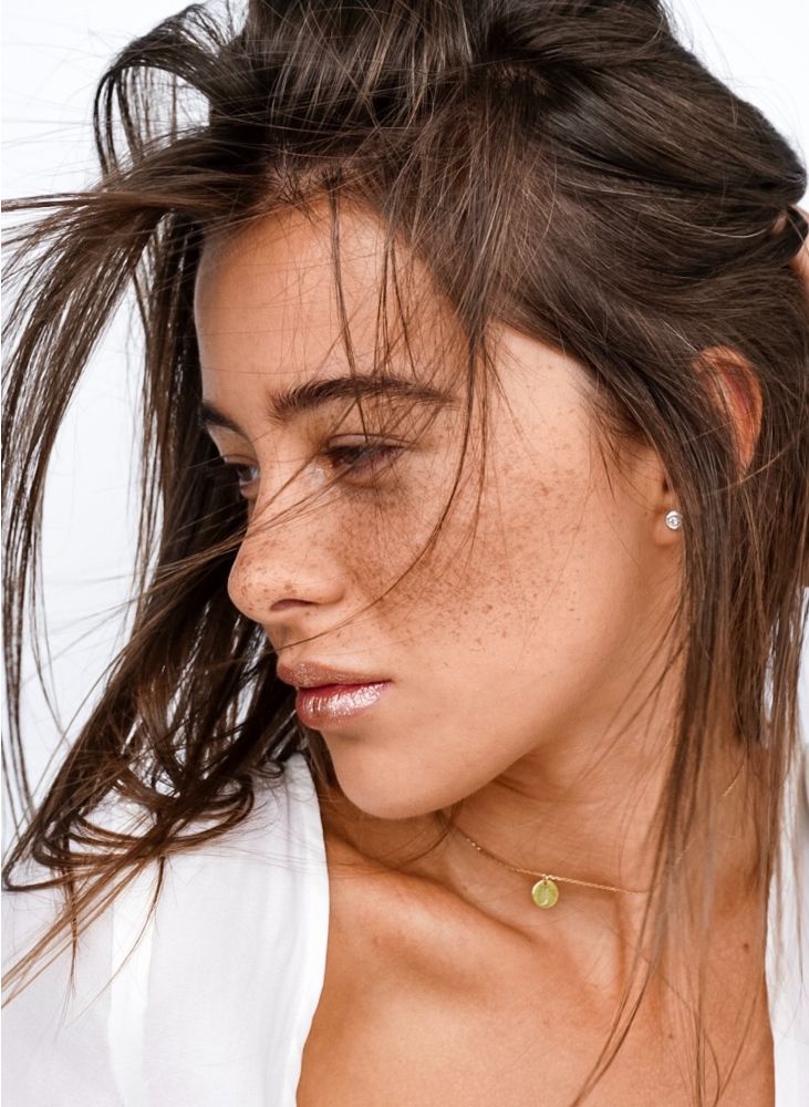 Woman with freckles and tousled hair.
