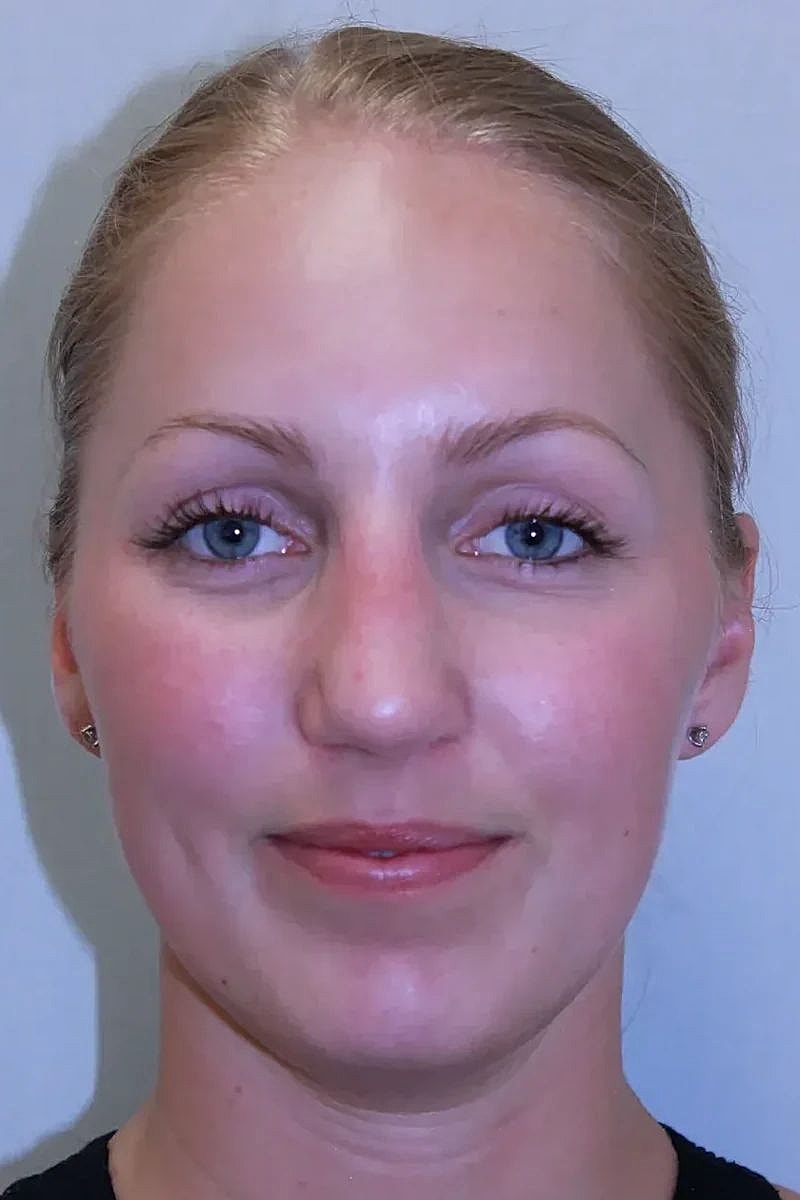 Woman with blonde hair and blue eyes.