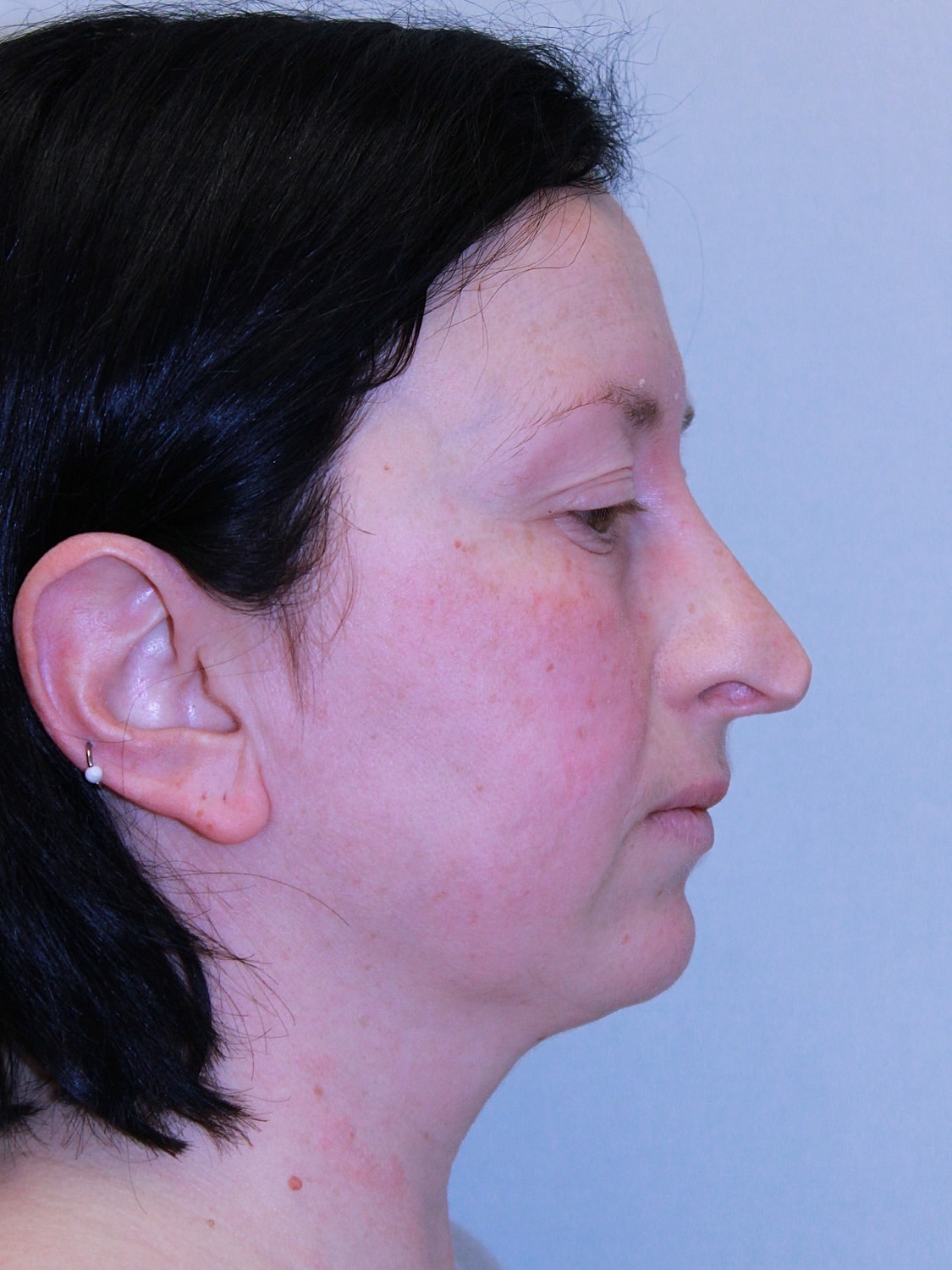 Profile view of a woman with dark hair.