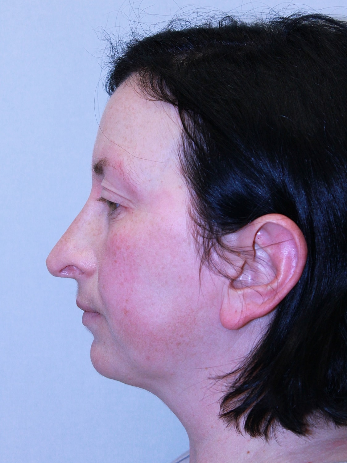 Profile view of a woman with dark hair.