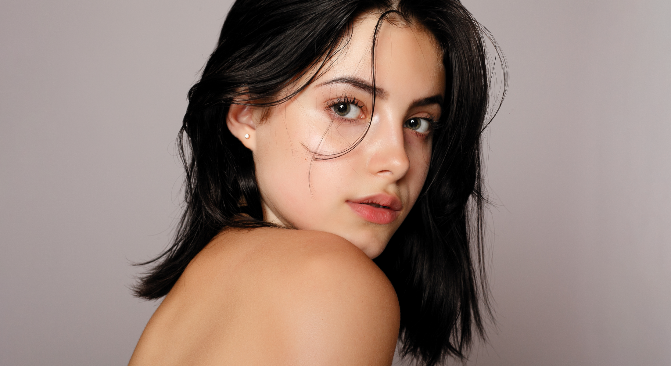 Young woman with dark hair, soft expression.
